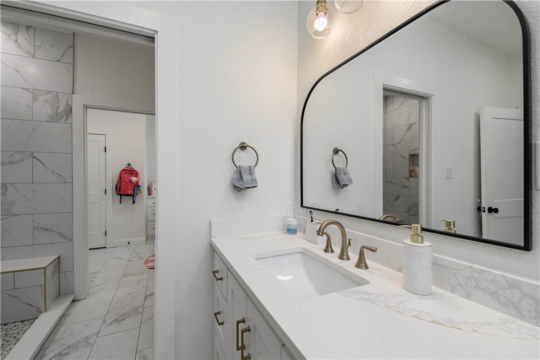 504 Eden Lane Bryan, TX 77803 - Photo 9 of 24 a bathroom with a double vanity sink mirror and double
