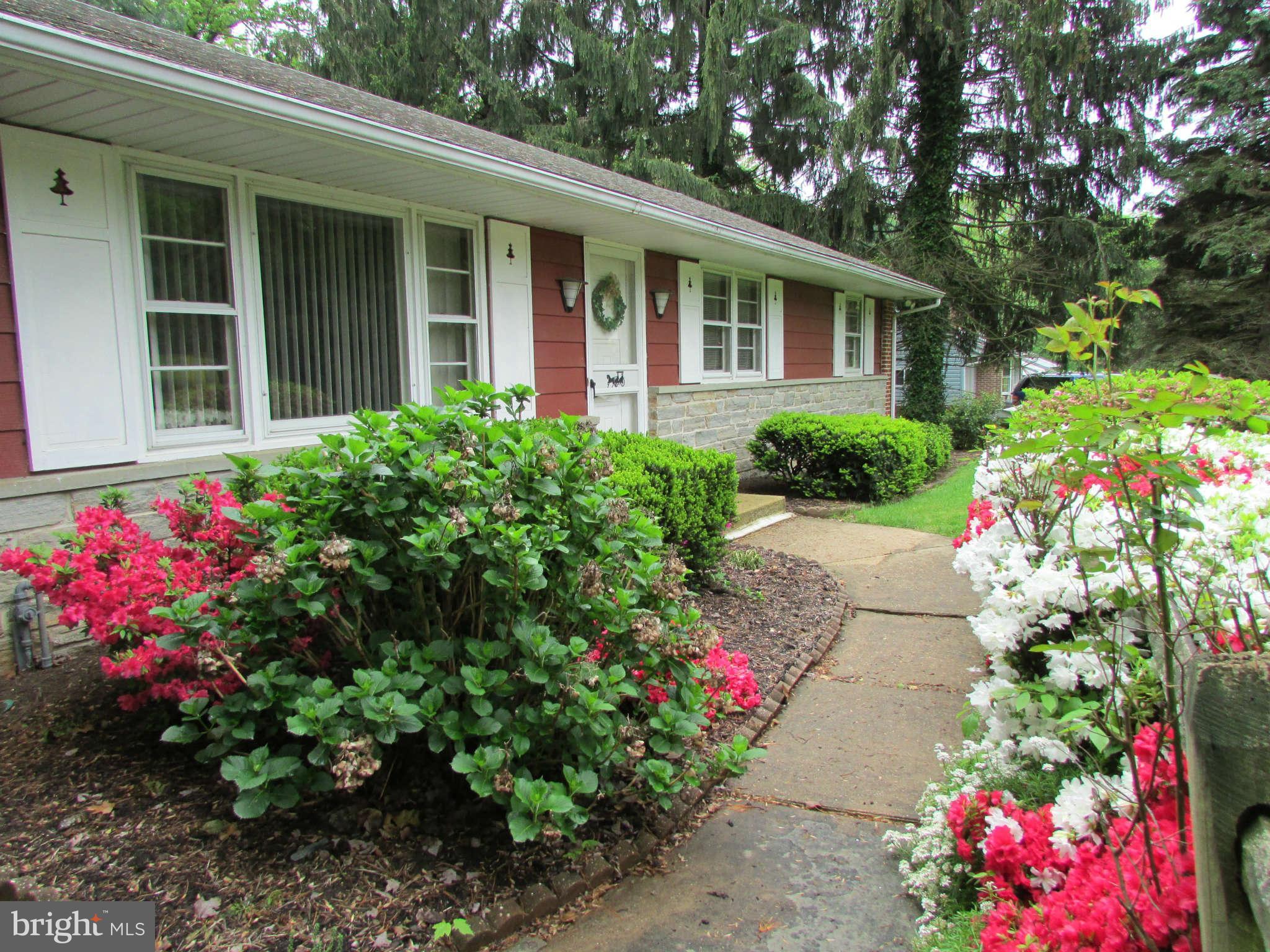 2409 Stoneybrook Road Fallston, MD 21047 - Photo 2 of 16 a front view of a house with a flower garden