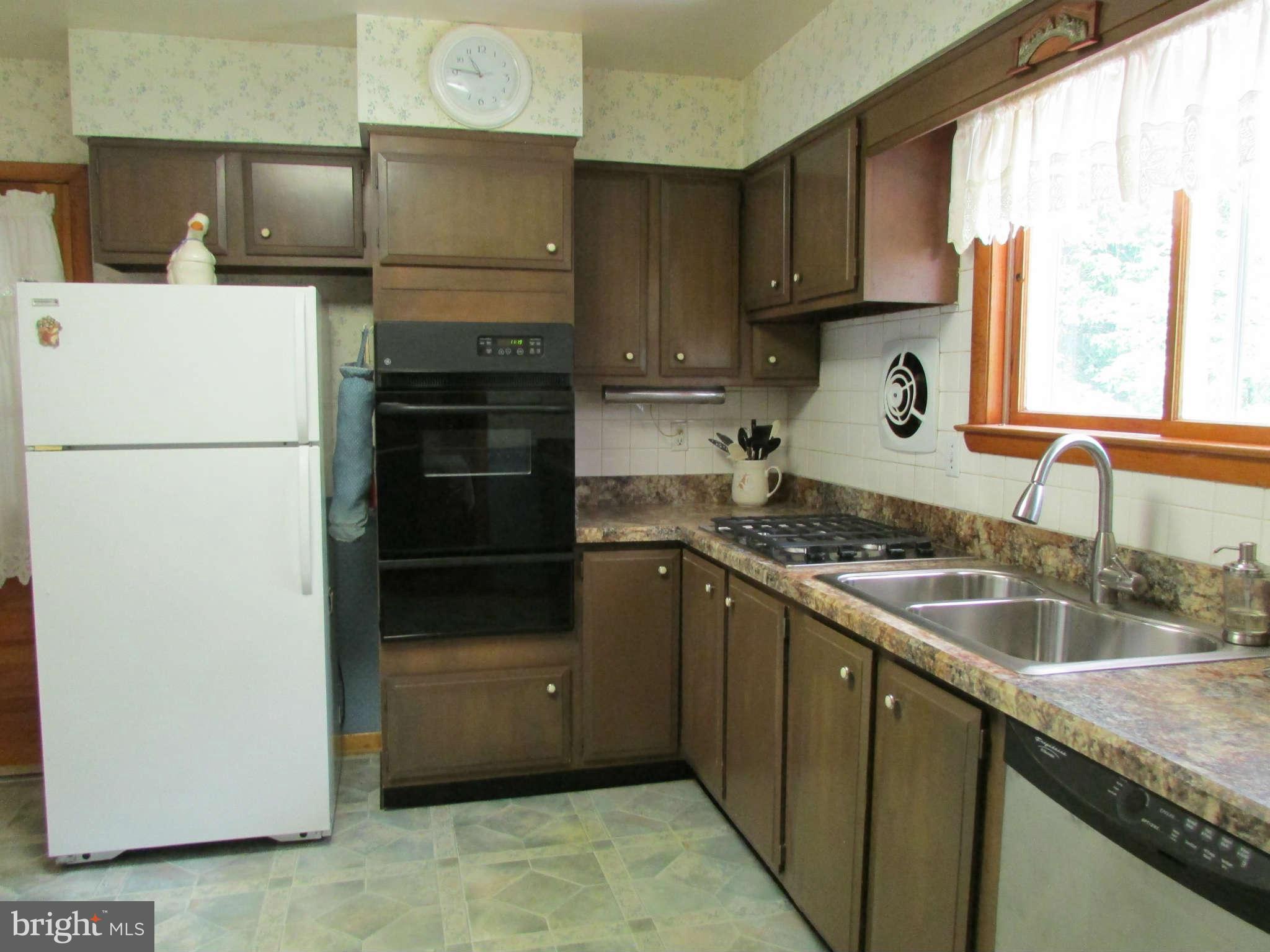 2409 Stoneybrook Road Fallston, MD 21047 - Photo 6 of 16 a kitchen with granite countertop a refrigerator and a sink