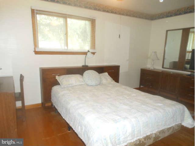 2409 Stoneybrook Road Fallston, MD 21047 - Photo 10 of 16 a large bed sitting in a bedroom next to a window
