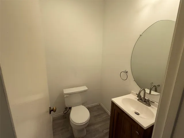 a bathroom with a sink toilet and mirror