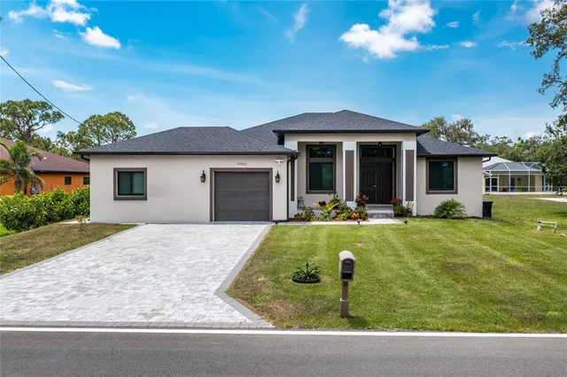 a view of a house with swimming pool and a yard