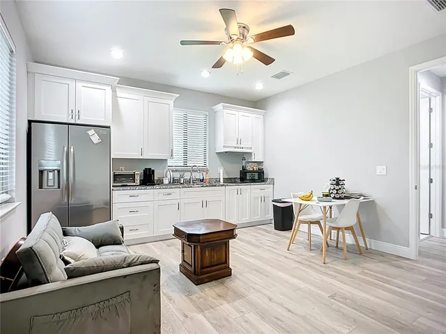 a kitchen with white cabinets and stainless steel appliances