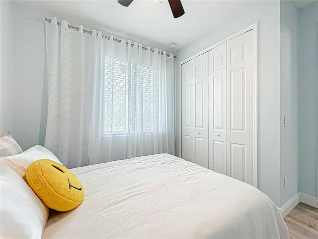 a bedroom with a bed and a window