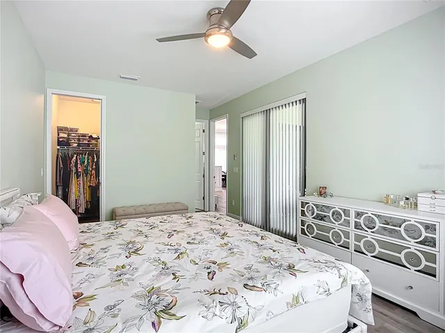 a bedroom with a large bed and a chandelier