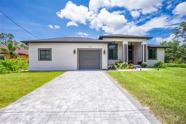 a front view of a house with a yard and garage