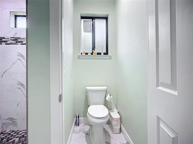 a white toilet sitting next to a bathroom sink