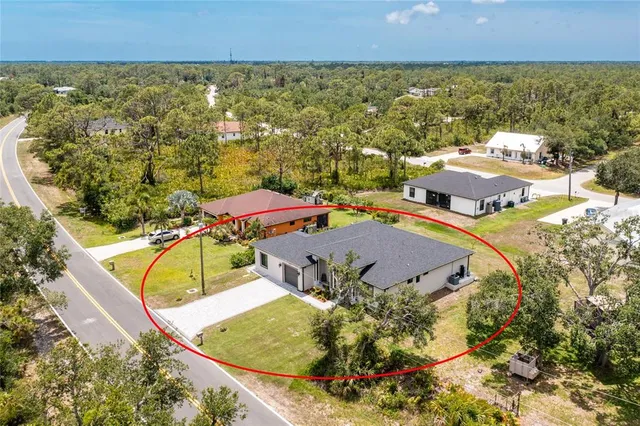an aerial view of residential houses with outdoor space