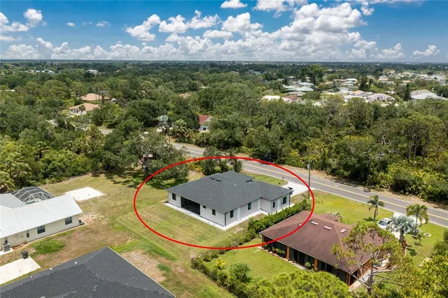 an aerial view of a house with a swimming pool