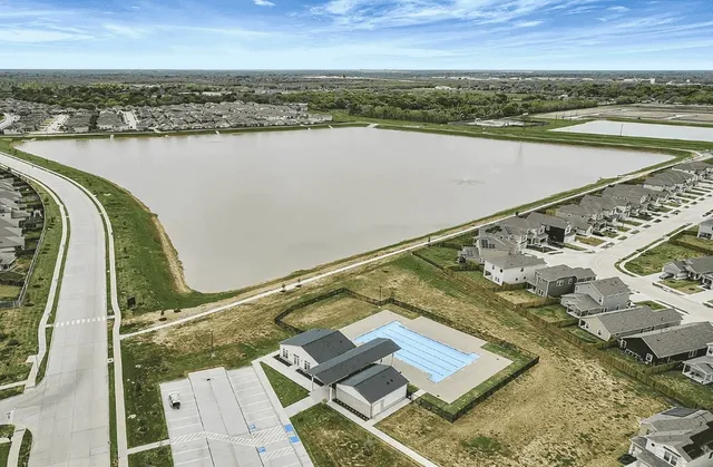 a view of a swimming pool with a yard