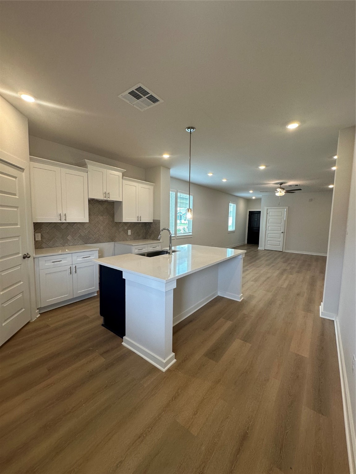 6414 Bolinas Court Rosharon, TX 77583 - Photo 3 of 18 a large kitchen with stainless steel appliances kitchen island a large counter top and a stove top oven