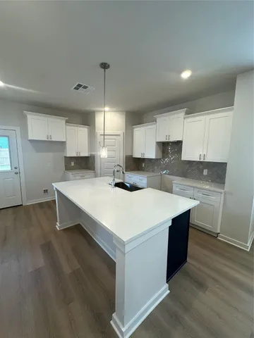 a kitchen with wooden cabinets and a sink