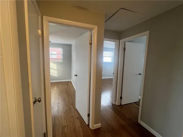 a view of a hallway with wooden floor