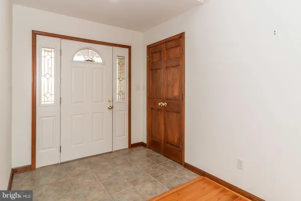 a kitchen with stainless steel appliances a stove top oven a sink a microwave and wooden cabinets