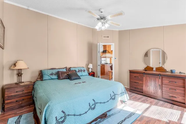 a bedroom with a large bed and a chandelier