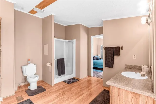 a bathroom with a sink toilet and shower