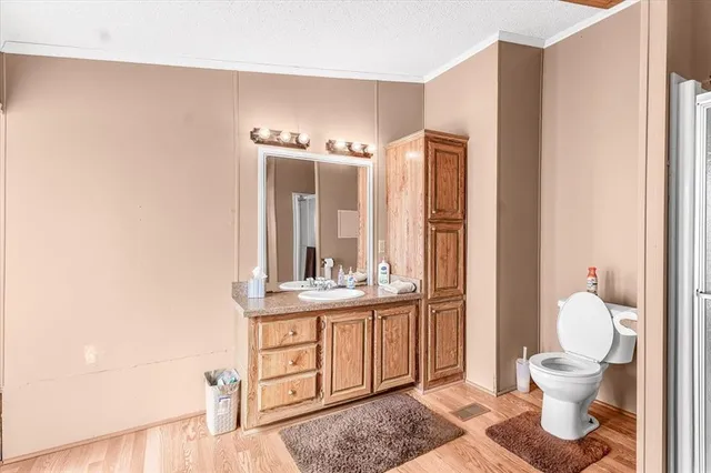 a bathroom with a toilet a sink and mirror