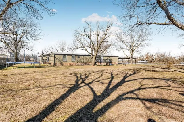 a view of yard covered with snow in front of house
