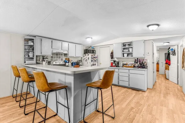 a kitchen with refrigerator and cabinets