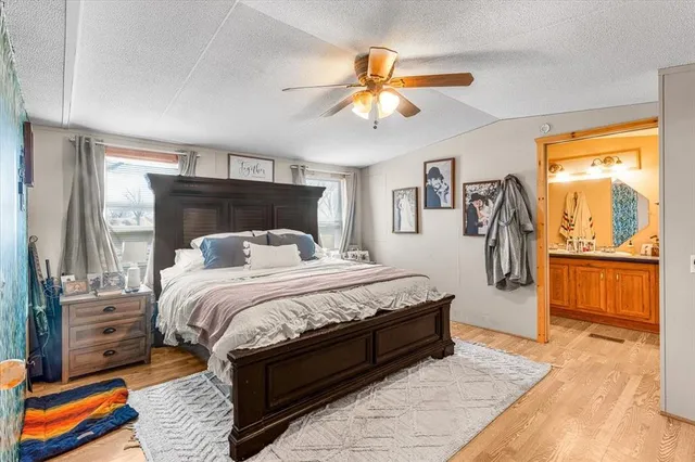 a bed sitting in a bedroom next to a window