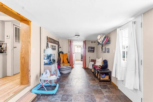 a living room with furniture a window and a flat screen tv