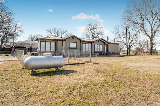 a front view of a house with a yard and covered with snow
