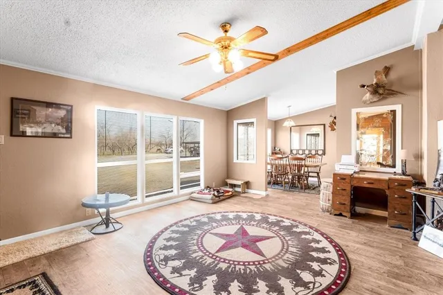 a living room with furniture large window and a table