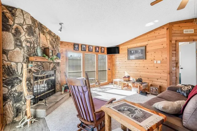 a living room with furniture and a floor to ceiling window