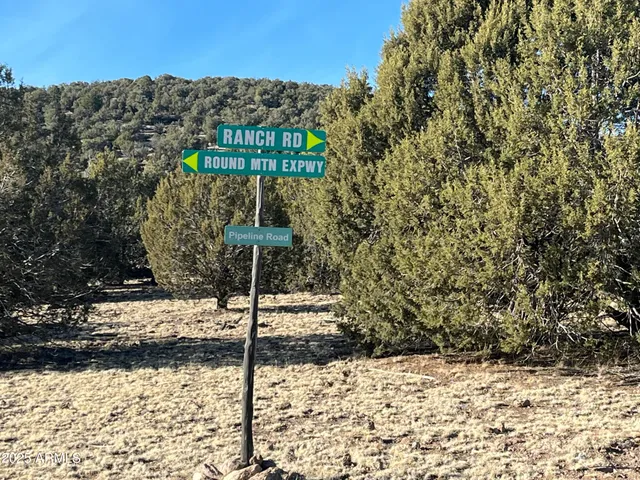a street sign on a wall next to a road