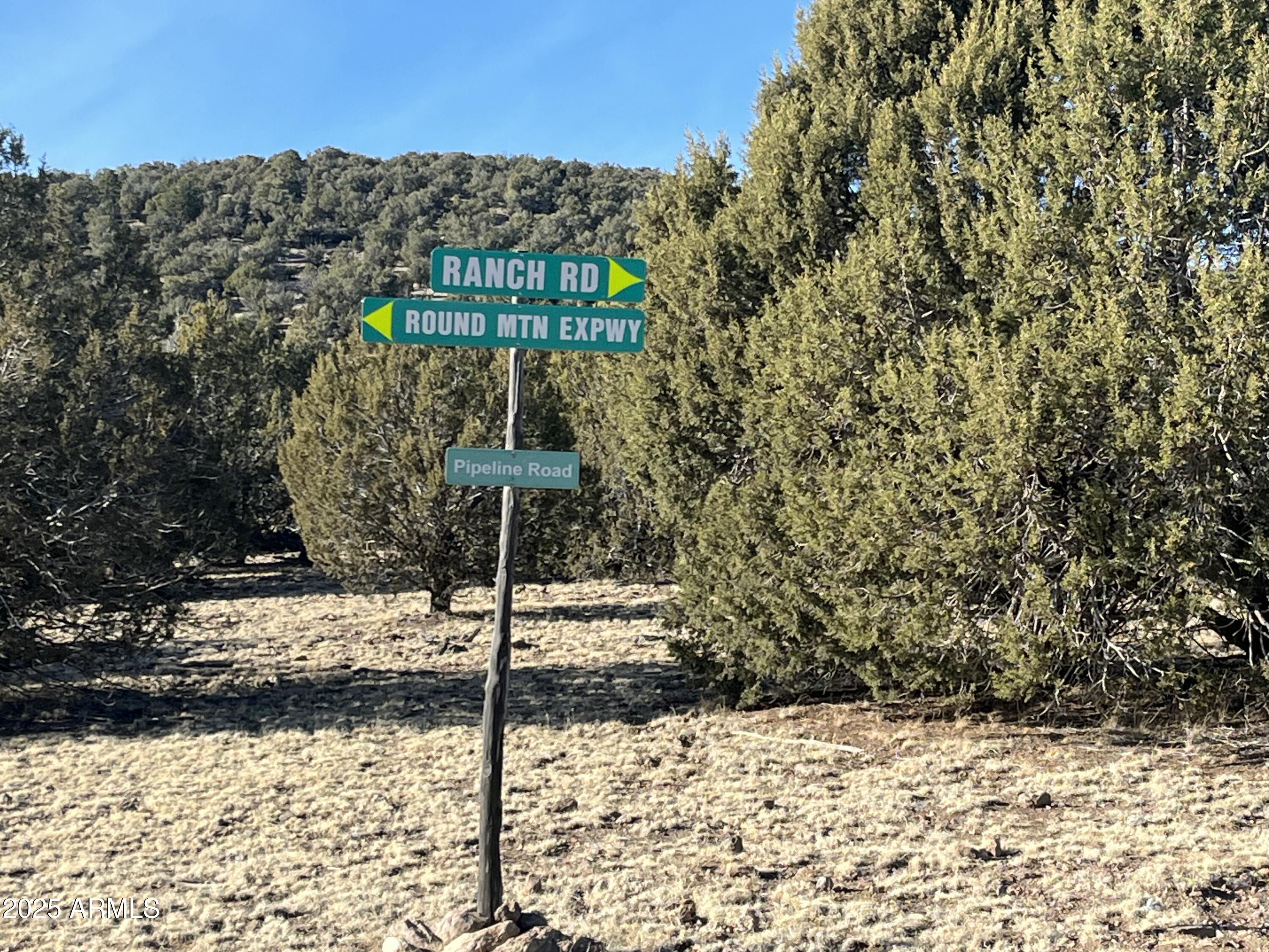 17411 Ranch Road, Unit 62 Williams, AZ 86046 - Photo 2 of 9 a street sign on a wall next to a road