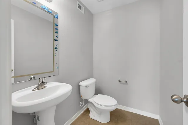 a bathroom with a sink toilet and a mirror