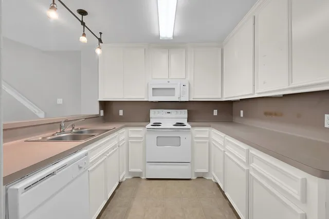a kitchen with a sink stove and cabinets