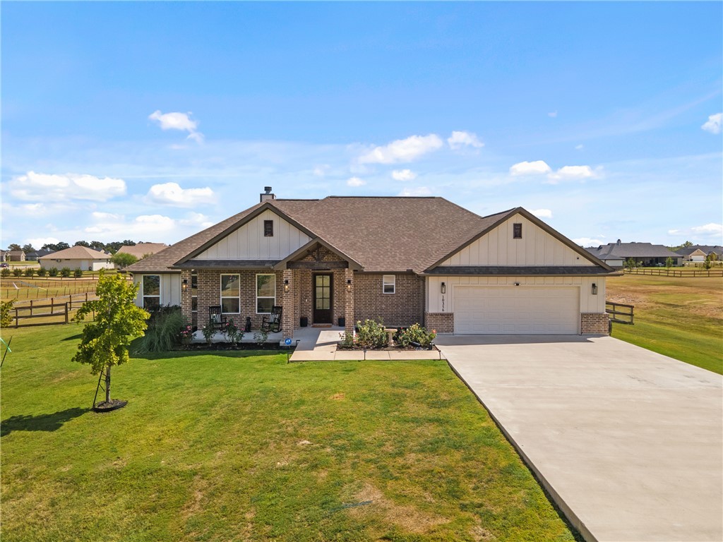 a view of a house with a yard and table