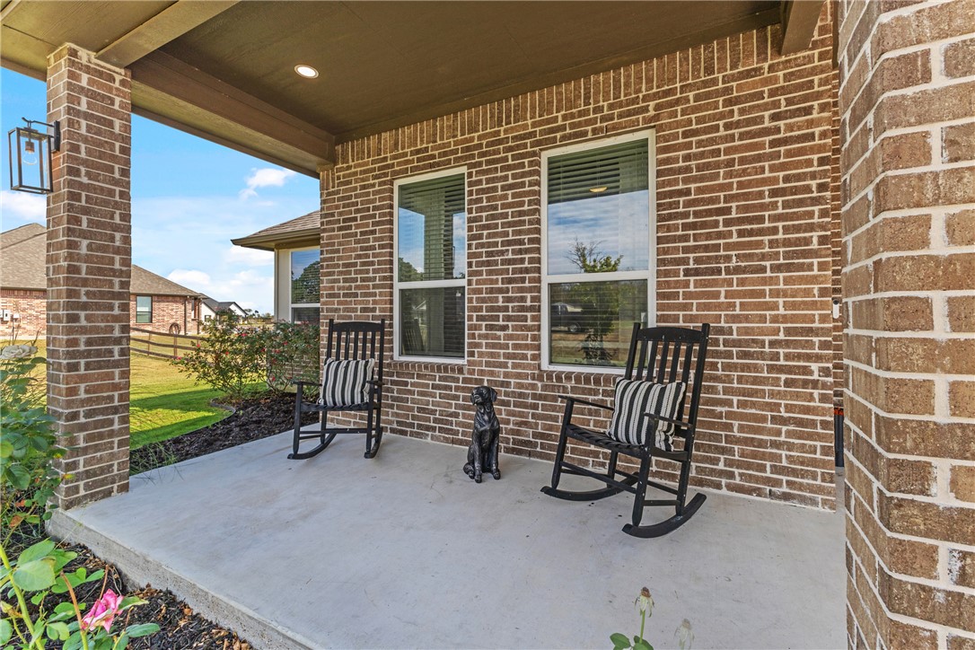 10356 Whiskey River Road Bryan, TX 77808 - Photo 11 of 39 a view of a porch with a bench and potted plants