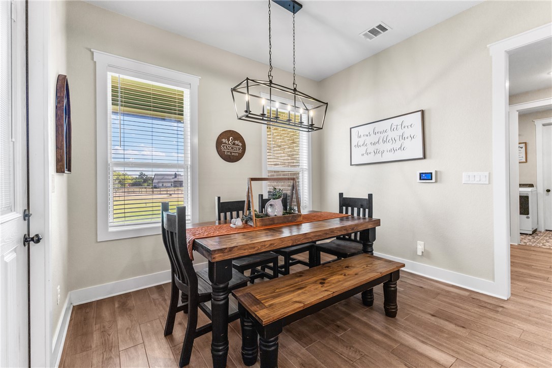 10356 Whiskey River Road Bryan, TX 77808 - Photo 17 of 39 a view of a dining room with furniture window and wooden floor