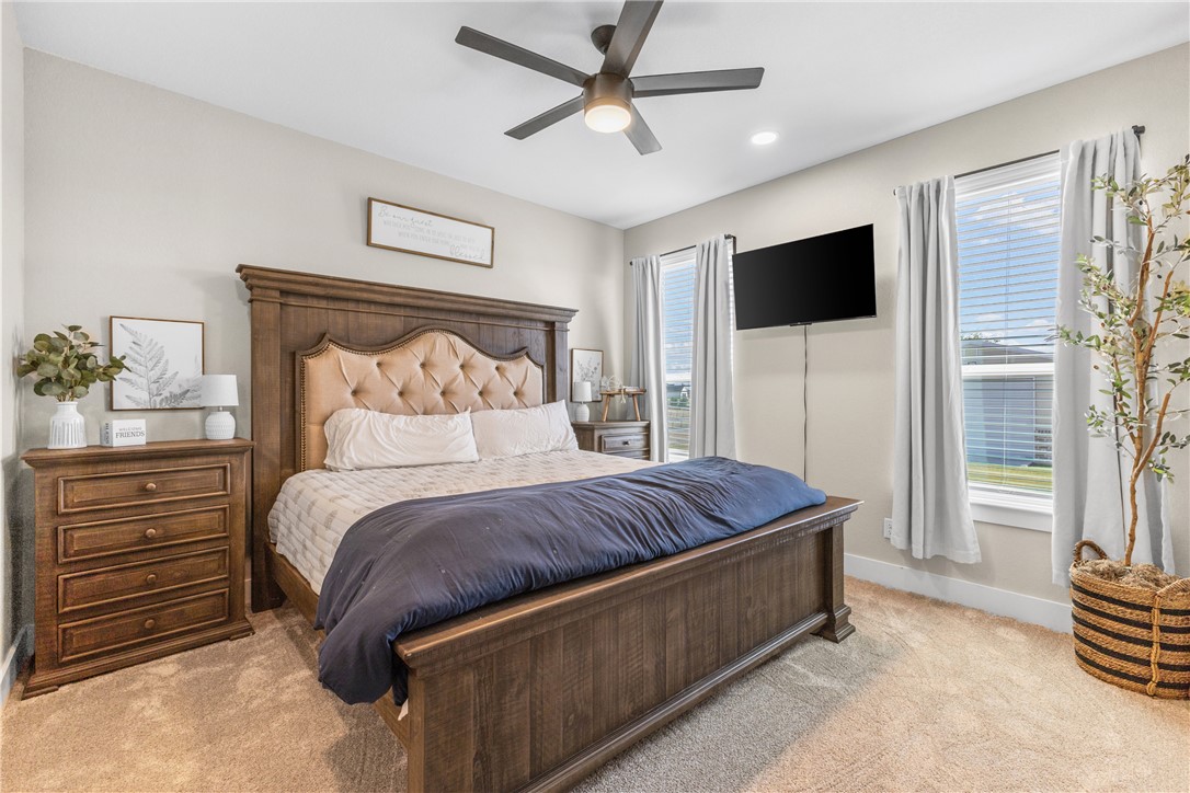 10356 Whiskey River Road Bryan, TX 77808 - Photo 24 of 39 a bedroom with a bed and a television