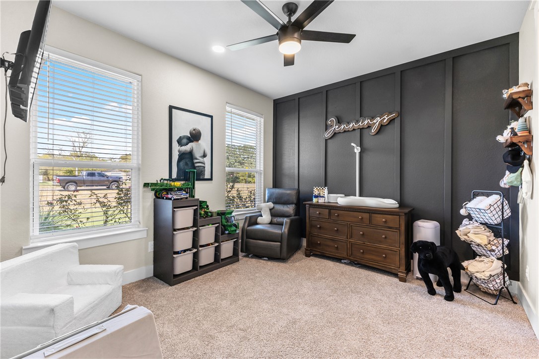 10356 Whiskey River Road Bryan, TX 77808 - Photo 29 of 39 a bedroom with a bed and a chandelier