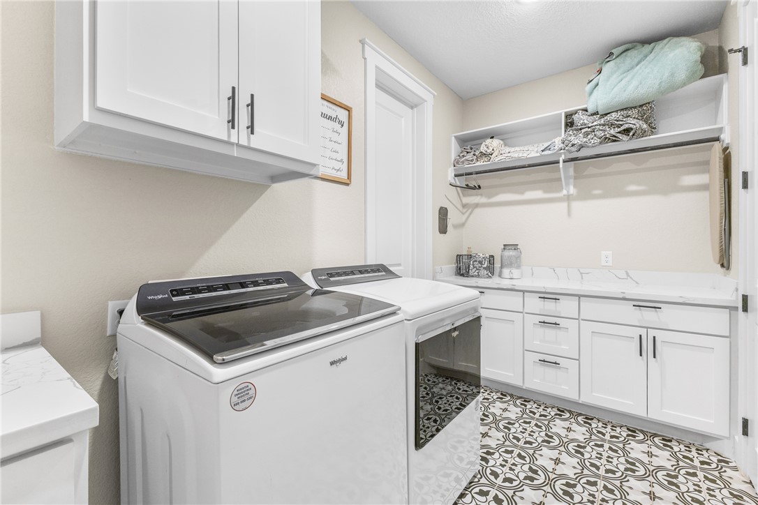 10356 Whiskey River Road Bryan, TX 77808 - Photo 3 of 39 a kitchen with a sink stove and cabinets