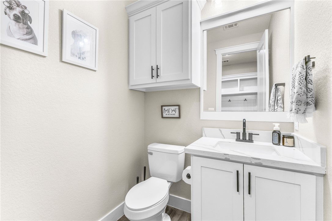 10356 Whiskey River Road Bryan, TX 77808 - Photo 32 of 39 a bathroom with a toilet sink and mirror