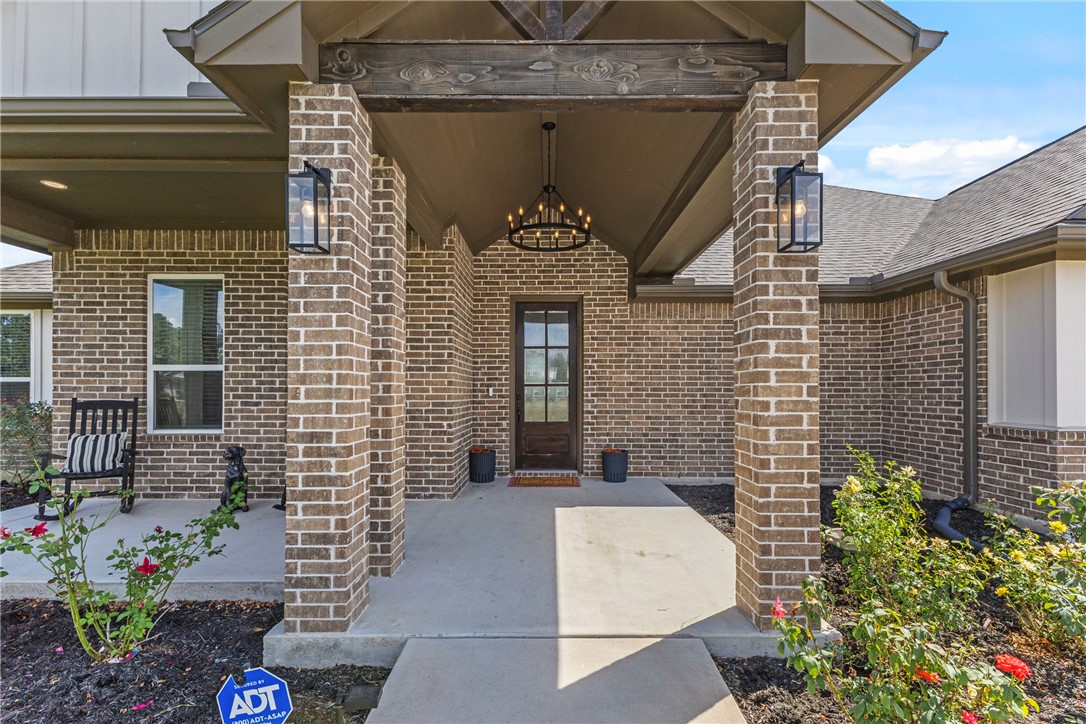 10356 Whiskey River Road Bryan, TX 77808 - Photo 10 of 39 a front view of a house with a garden