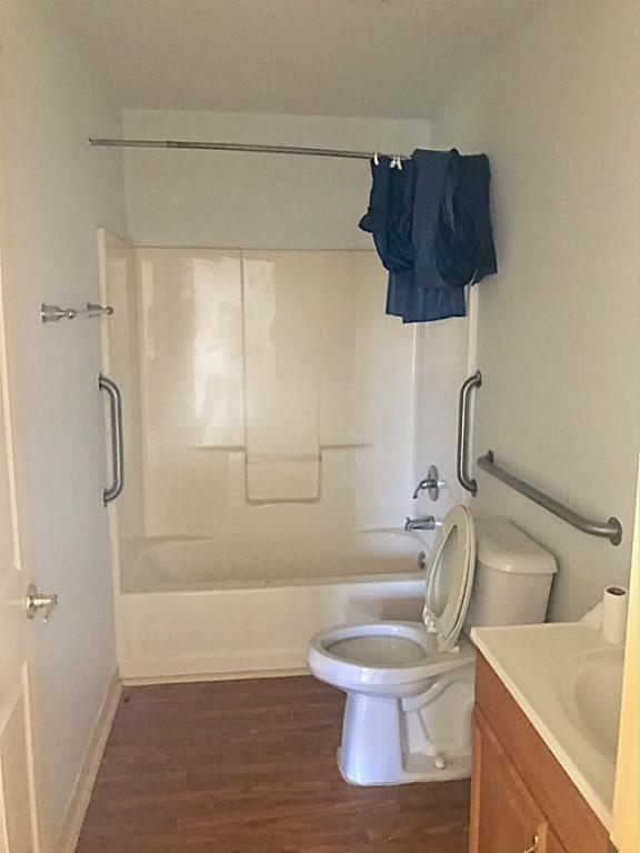 a bathroom with a shower a toilet and sink