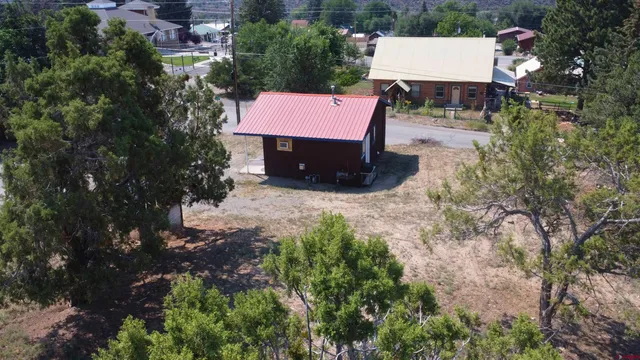 an aerial view of a house with a yard and lake view