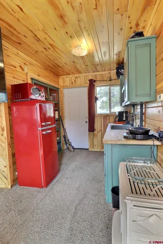 a view of a chairs and table in the backyard