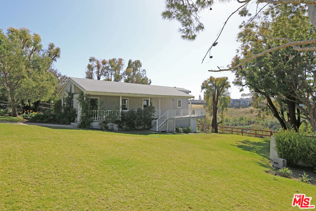 a view of a house with a yard and a garage