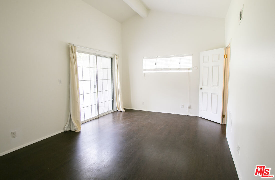 6557 Wandermere Road, Unit GH Malibu, CA 90265 - Photo 14 of 17 an empty room with wooden floor and windows