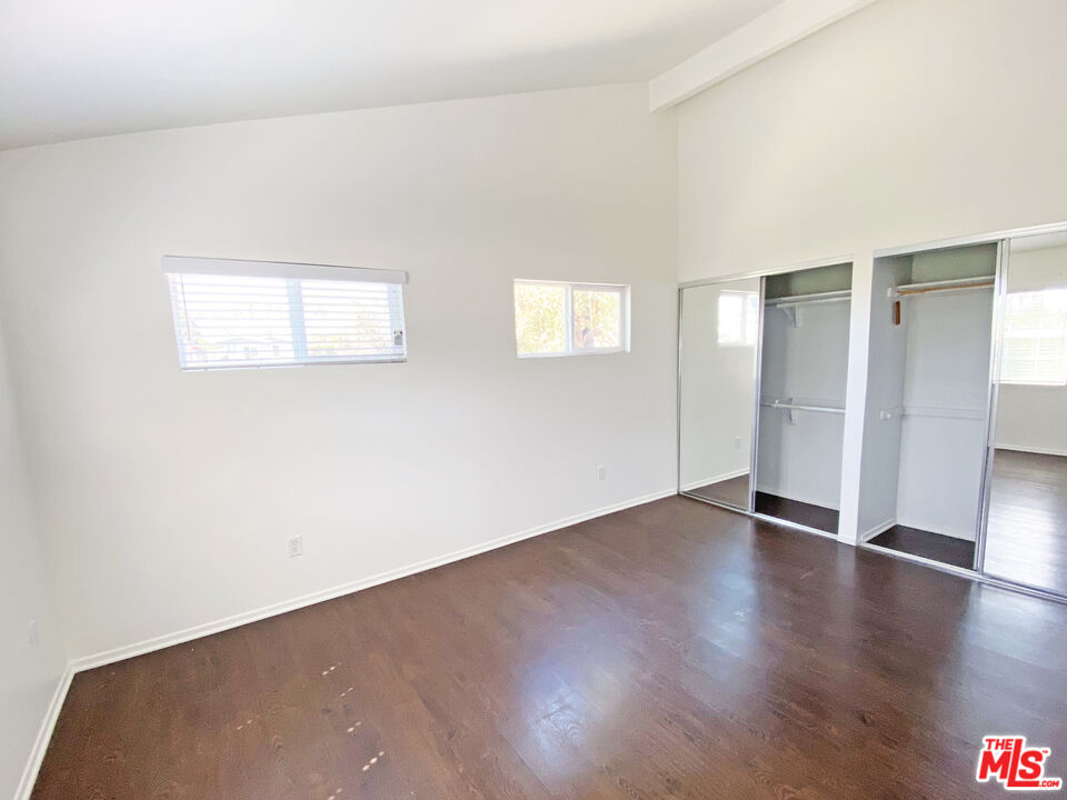 6557 Wandermere Road, Unit GH Malibu, CA 90265 - Photo 16 of 17 an empty room with wooden floor & windows