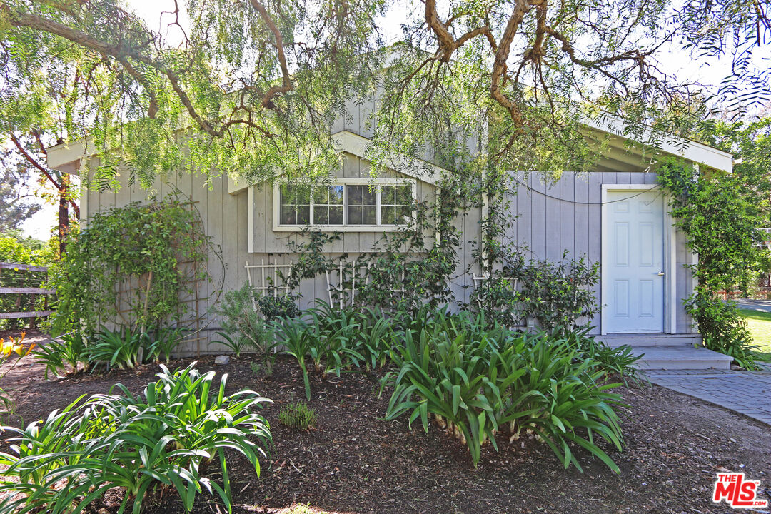 6557 Wandermere Road, Unit GH Malibu, CA 90265 - Photo 3 of 17 a front view of a house with a yard