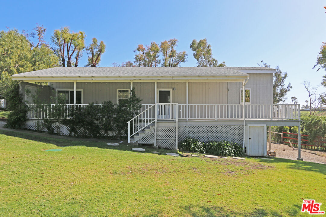 6557 Wandermere Road, Unit GH Malibu, CA 90265 - Photo 4 of 17 a front view of a house with a yard