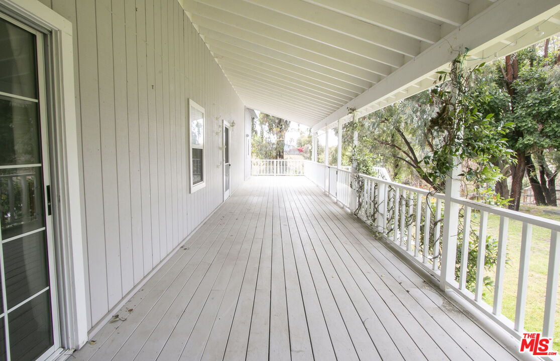6557 Wandermere Road, Unit GH Malibu, CA 90265 - Photo 6 of 17 a view of a porch with wooden floor and outdoor space