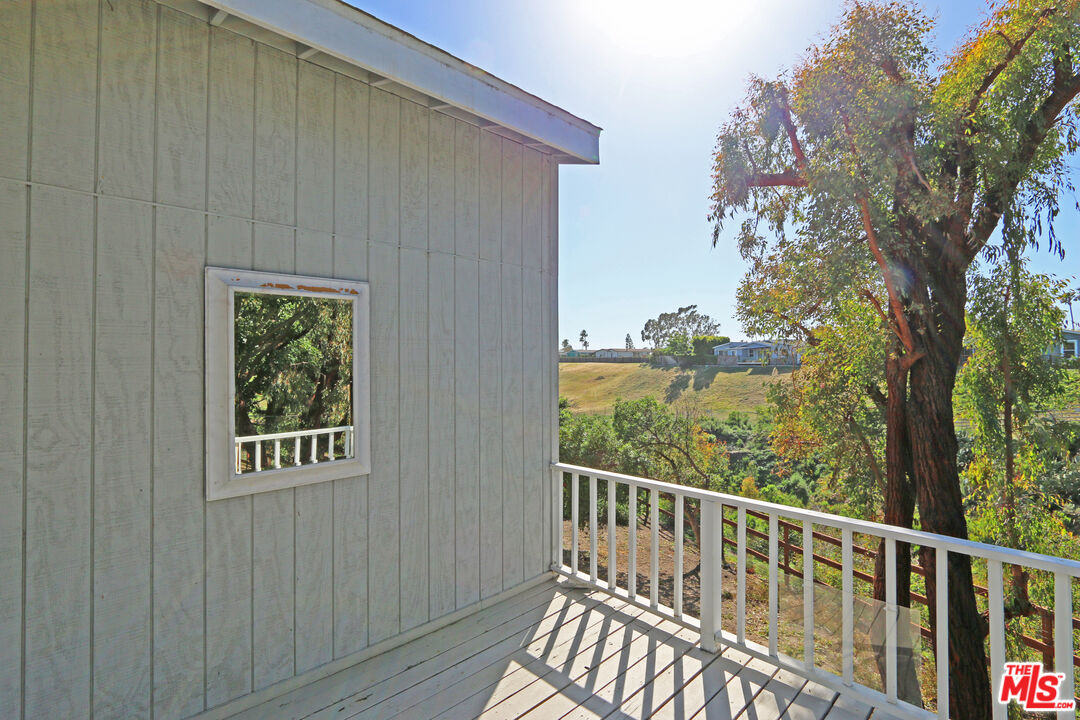 6557 Wandermere Road, Unit GH Malibu, CA 90265 - Photo 7 of 17 a view of a balcony with wooden floor and fence